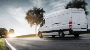 White ford transit van driving on the road